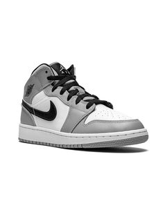 Light smoke grey/black/white leather Air Jordan 1 Mid sneakers from NIKE KIDS featuring round toe, flat rubber sole, front lace-up fastening, branded insole and signature Swoosh logo detail. These styles are supplied by a premium sneaker marketplace. Stocking only the most sought-after footwear, they source and curate some of the most hard to find sneakers from around the world. | Jordan Kids Air Jordan 1 Mid sneakers Snicker Shoes, Nike Shoes For Boys, Nike Jordans, Pretty Sneakers, Jordan Boys, Mid Sneakers, Best Shoes For Men, Grey Sneakers, Swoosh Logo