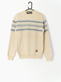 80s vintage Eisbär wool jumper in beige and blue, made in Austria. This jumper features a crew neck and an Eisbär embroidered logo on the bottom left of the jumper. Made in Austria from a heavy weight coarse wool, this jumper is ideal for staying toasty warm in the winter months. Our recommended size: Medium Label says: Medium to large Condition: Very good  Material: 100% pure new wool Measurements in inches: Pit to pit: 20 Shoulders: 18 Front length: 27.5 Back length: 27 Sleeve length: 25.5 Hem Cream Retro Winter Sweater, Beige Crew Neck Sweater, Vintage Crew Neck Sweater For Winter, Cozy Beige Crew Neck Sweater, Cream Crew Neck Sweater For Winter, Retro Cotton Beige Sweater, Retro Beige Cotton Sweater, Vintage Wool Crew Neck Sweater, Retro Crew Neck Cream Sweater