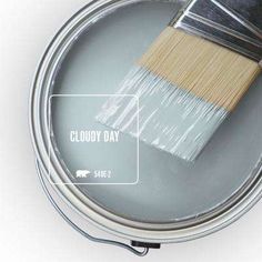 a paint can with a brush in it