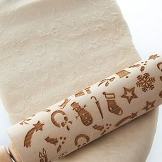 a roll of toilet paper sitting on top of a toilet seat with christmas themed designs