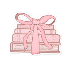 a stack of books with a pink bow on top