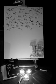 a white board with writing on it next to candles