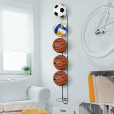 The perfect addition to any gym, garage, or shed this wall mounted black metal sports ball storage racks keeping your space neat, tidy and stylish. Simply mount to most wall surfaces with proper mounting hardware to easily store and conveniently access your basketballs, soccer balls, volleyballs, footballs, or sports and medicine balls or even kettle bells. With six metal rings you will double your storage, and create more floor space while keeping your sports and exercise balls from rolling aro Sports Wall Storage, Sports Boys Room Walmart, Boys Sports Room Walmart, Boys Trainer Storage, Ball Wall Shelf, Swiss Ball Storage, Sports Ball Storage, Bedroom Sport, Soccer Bedroom