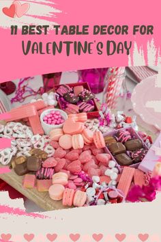 valentine's day table with pink and white decorations, chocolates and candy bars