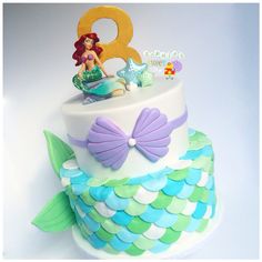 a birthday cake decorated with an ariel the mermaid theme