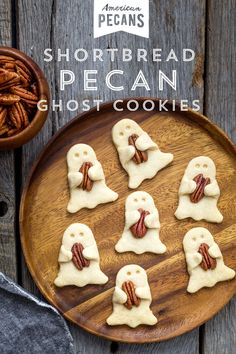 several small ghost cookies on a plate with pecans in the background and text overlay that reads shortbread pecan ghost cookies