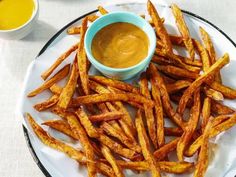 french fries on a plate with dipping sauce