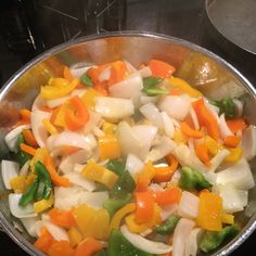 a pan filled with vegetables on top of a stove