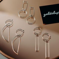 "Very lightweight and easy to wear everyday hoop earrings with a circle drop. Made with 20 gauge wire - about .8mm thick. A perfect addition to a minimalist capsule wardrobe. Dainty enough to wear on a daily basis but dressy enough for a special occasion. These minimalist hoops are available in 14k gold fill or sterling silver - about 2\" long. Size may vary slightly due to the handmade nature of these earrings. See photos provided on ear for scale. Please note these earrings are handmade to ord Minimalist Metal Hoop Wrap Earrings, Modern Hoop Threader Earrings As Gift, Minimalist Nickel-free Open Circle Hoop Earrings, Modern Nickel-free Hoop Wrap Earrings, Wire Hoop Earrings, Minimalist Capsule Wardrobe, Delicate Earrings, Capsule Wardrobe, Handmade Natural