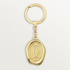 Cartier - Key ring Double C Logo - Key ring Woman Metal - Keyring with golden-finish wax seal motif. Medallion dimensions: 1.35” high x 1” wide Luxury 14k Gold-tone Rings, Designer Polished Gold Rings, Designer Gold Rings With Polished Finish, Designer Gold Ring With Polished Finish, Luxury Gold Jewelry With Gold-tone Logo Plaque, Oval Cartier Hallmarked Jewelry, Cartier Oval Hallmarked Jewelry, Luxury Oval Signet Ring With Intaglio, Luxury Formal Signet Ring With Intaglio