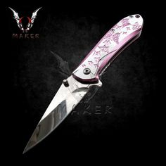 a pink and white knife with skulls on it's blade is shown against a black background