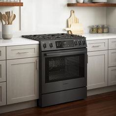 a black stove top oven sitting inside of a kitchen