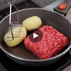 a frying pan with meat and potatoes cooking on the stove top next to an electric burner