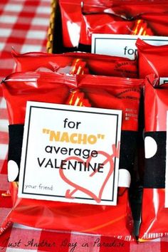 several packets of nachos are sitting on a red and white tablecloth with the words for nacho'average valentine written on them