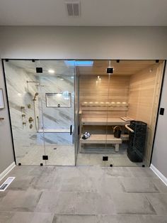 a bathroom with a walk in shower next to a tiled floor