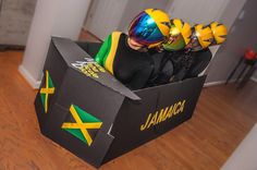 two people wearing yellow and green helmets in a cardboard box with jamaica written on it