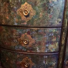 an old dresser with peeling paint on it