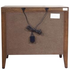 an electronic device is plugged into the back of a wooden box with wires attached to it