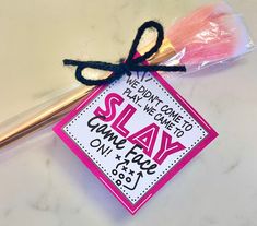 a pink and white sign with the word slay on it next to a pair of scissors