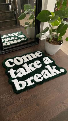 a pair of green and white doormats sitting on top of a wooden table