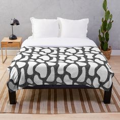 a black and white geometric pattern on a bed