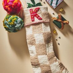 a christmas stocking with crochet and yarn on it next to other items