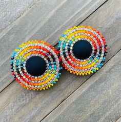 pair of multicolored beaded earrings on wooden surface