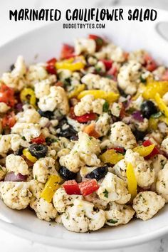 a white plate topped with cauliflower salad