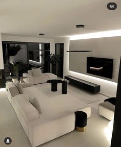 a modern living room with white furniture and black accents