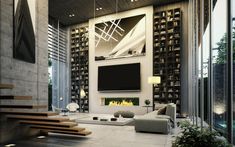 a modern living room with stairs leading up to the ceiling and a flat screen tv mounted on the wall