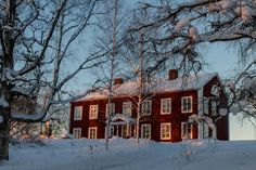 a large red house in the middle of winter