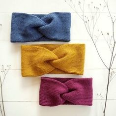 three knitted headbands on top of each other, one with a knot