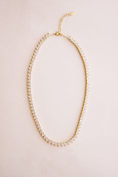 Introducing our Queen's Heart Tennis Necklace, the perfect way to add a little romance to your style! Featuring a row of heart-shaped stones set in a delicate 14k gold-plated design, this necklace brings a touch of royal charm to any outfit. Ideal for casual days, date nights, or glamorous evenings, the Queen's Heart Necklace makes every look feel extra special. It's a chic and versatile piece you'll reach for time and time again! NECKLACE FEATURES Material: Brass, White Cubic Zirconia Dimension Elegant Heart-shaped Tennis Necklace, Elegant Heart-shaped Tennis Necklace For Gift, Bridal Jewelry Collection, Pearl Collection, Bridesmaid Bracelet, Birthstone Gifts, Bridal Bracelet, Tennis Necklace, Bridal Necklace