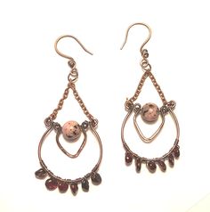 Copper earrings , chandelier style with a center round sesame Jasper orchid bead and it has 6 garnet nugget beads on the bottom.  Ear hooks are attached to the top copper chain.  Earrings have been oxidized and polished for an antique look. Artisan Beaded Dangle Earrings With Natural Stones, Artisan Dangle Beaded Earrings With Natural Stones, Artisan Natural Stone Beaded Dangle Earrings, Artisan Natural Stone Dangle Beaded Earrings, Artisan Dangle Earrings With Polished Beads, Copper Beaded Dangle Earrings With Dangling Beads, Bohemian Wire Wrapped Round Chandelier Earrings, Earrings Chandelier, Chandelier Style