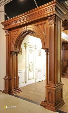 an ornate wooden archway in the middle of a room