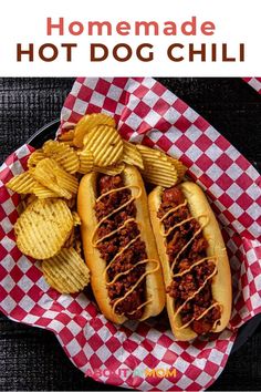 two hot dogs with chili and chips in a basket