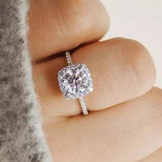 a woman's hand with a diamond ring on top of her finger and the words, how to choose an engagement ring