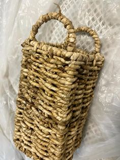 a woven basket sitting on top of a plastic bag