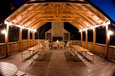 an outdoor covered patio with benches and tables