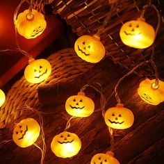 pumpkin shaped string lights with faces on them