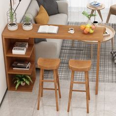 a living room with a couch, table and two stools in front of it