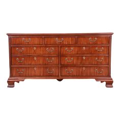 a large wooden dresser with many drawers on it's sides and two doors at the top