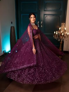 This jewelled purple lehenga features all over tonal sequin, crystal and cutdana embroidery. Paired with a strappy blouse with tassel string detailing and an embroidered dupatta in net.DELIVERY TIMEPlease allow 8-12 weeks for your outfit to arrive.FABRIC DETAILSNetProfessional cleaning only. Purple Sequin Dresses With Traditional Drape, Purple Sets With Sheer Dupatta For Reception, Purple Reception Sets With Sheer Dupatta, Reception Sets With Purple Sheer Dupatta, Purple Sequined Traditional Wear For Diwali, Purple Sequined Sets For Navratri, Purple Sequins Sets For Navratri, Purple Sequined Lehenga For Navratri, Purple Semi-stitched Sequined Choli