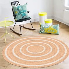 a living room with a rocking chair and rug