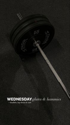 a black and white photo with the words wednesday on it, next to a barbell