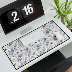 a computer desk with a clock and keyboard on it