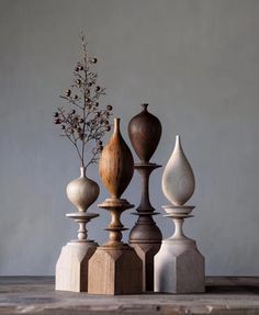 four vases are stacked on top of each other