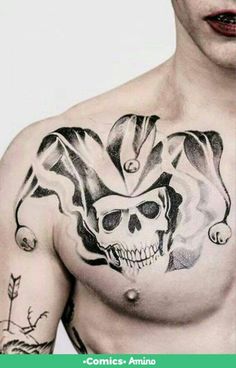 a shirtless man with tattoos on his chest and face painted like a skull is posing for the camera