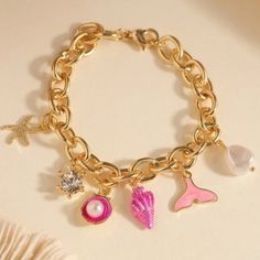 Pink Seashells, Pearls, And Gold Charm Bracelet For Sale! This Charm Bracelet Is New And Is From My Boutique! It Has Beautiful Shell Charms That Are Dangling From A Gold Chain! The Chain Is Made Out Of Stainless Steel. It Is Just Over 7 Inches Long When Unclasped. Such A Great Bracelet To Add To Your Jewelry Collection! Measurements: Bracelet Length: 7.2 Inches Pink Metal Bracelets For Party, Trendy Pink Metal Bracelets, Trendy Pink Metal Bracelet, Trendy Pink Charm Bracelets, Trendy Pink Bracelets With Charms, Pink Charm Bracelet For Beach, Pink Bracelet With Lobster Clasp For Party, Pink Metal Charm Bracelet With Charms, Pink Metal Bracelet With Charms