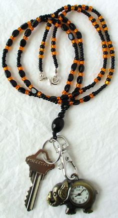 This orange & black beaded lanyard, can be used as a badge holder, an I.D. holder, keychain necklace, watch holder - it's a multi-use accessory for home or office! 34" in length, made with glass beads, beading cord, metal lobster clasp, clip, and keyring. Snap on badge holder included with every lanyard purchase. This orange & black beaded lanyard ships to you in a gift box, ready to give as a present or to keep and store. Note: Watch not included with purchase. Back to Beaded Lanyards Everyday Black Beaded Jewelry, Adjustable Black Lanyard With Key Clip, Adjustable Black Lanyards With Key Clip, Black Beaded Adjustable Lanyards, Adjustable Black Badge Holder With Key Leash, Handmade Black Lanyards, Black Beaded Lanyard As Gift, Black Beaded Lanyards As Gift, Black Beaded Lanyards For Gift